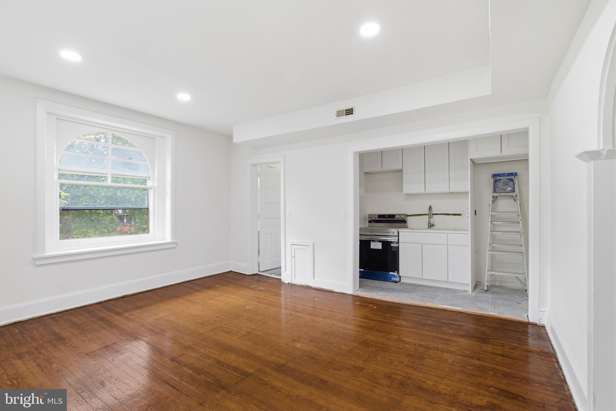 5939 Drexel Road, Unit 2 Philadelphia, PA 19131 - Photo 2 of 17 a kitchen with a refrigerator and white cabinets