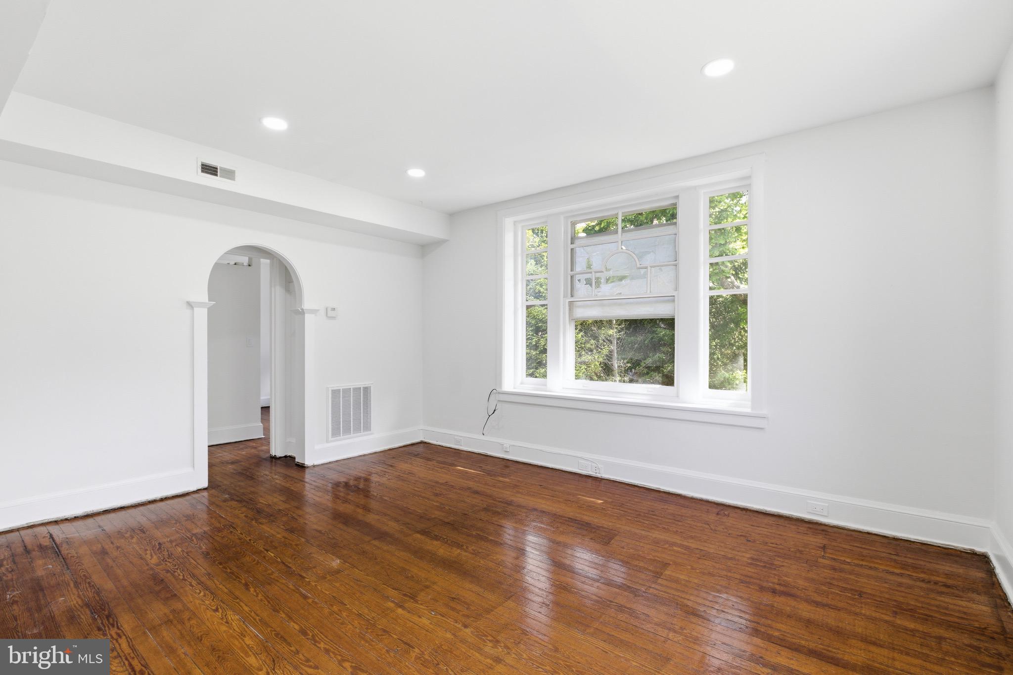 5939 Drexel Road, Unit 2 Philadelphia, PA 19131 - Photo 9 of 17 an empty room with wooden floor and a window