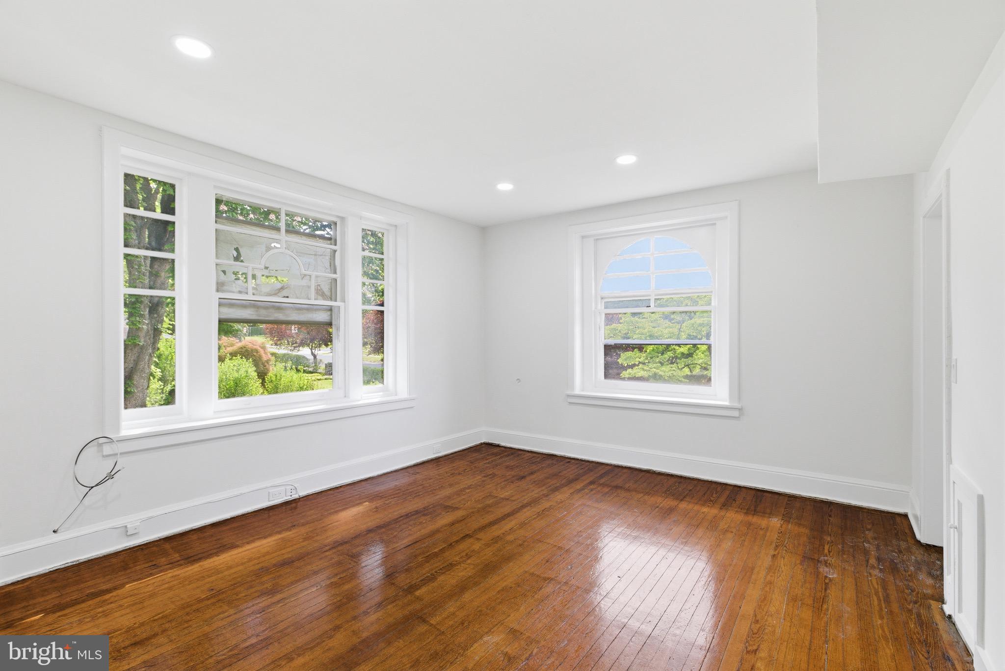 5939 Drexel Road, Unit 2 Philadelphia, PA 19131 - Photo 10 of 17 an empty room with wooden floor and windows