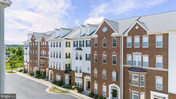 a view of a large brick building next to a yard