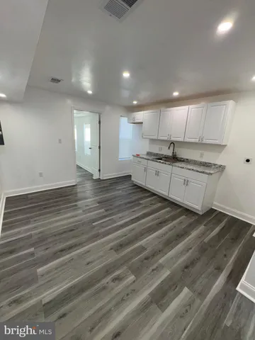 a large kitchen with stainless steel appliances granite countertop a dishwasher and a stove