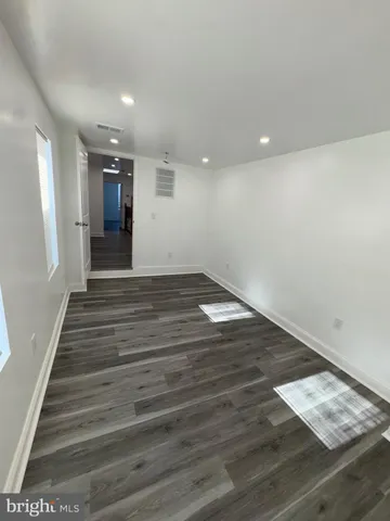 a view of a room with wooden floor and cabinet