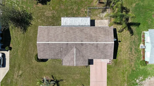 an aerial view of a house with a yard