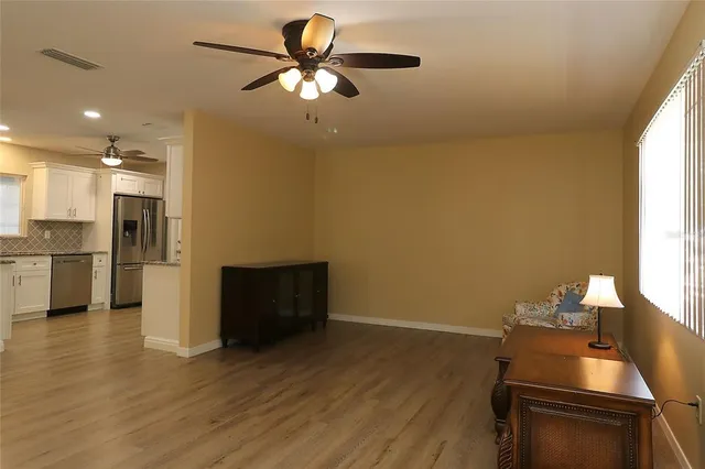 a view of a kitchen with a stove wooden cabinets and a wooden floor
