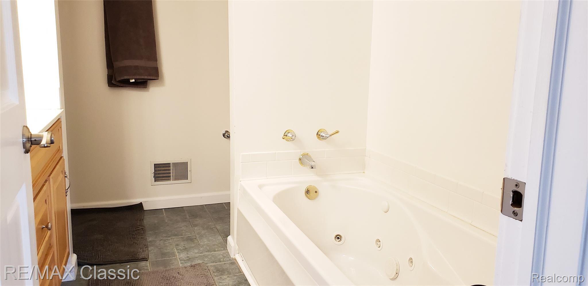 8070 Oak Grove Road Howell, MI 48855 - Photo 29 of 34 Master bathroom with jetted tub, shower & double sinks