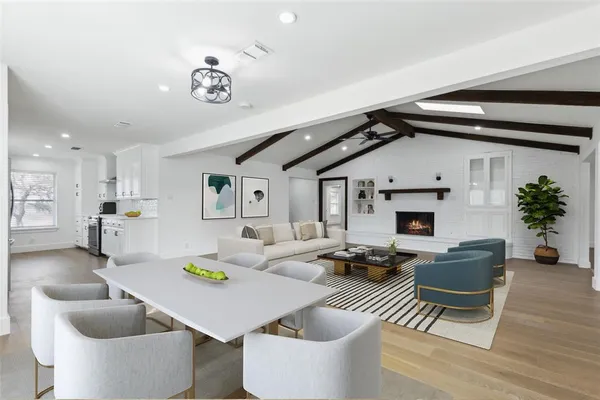 a living room with furniture a fireplace and a table