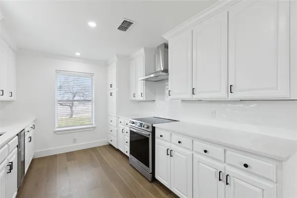 a kitchen with granite countertop white cabinets and white appliances