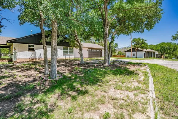 a backyard of a house with table and chairs