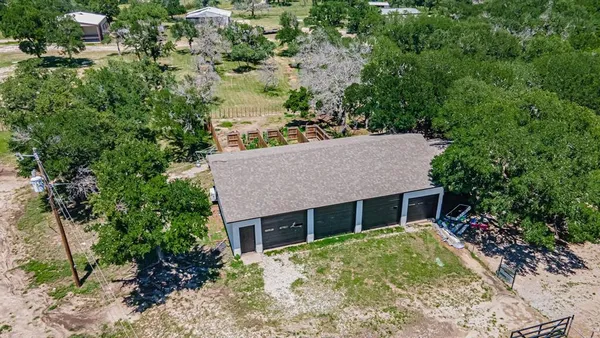 a view of a backyard with large trees