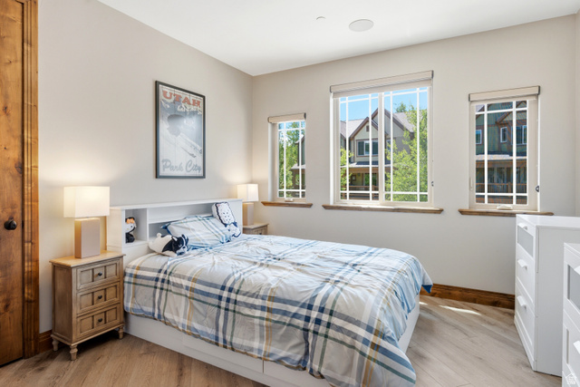 3148 Lower Saddleback Road Park City, UT 84098 - Photo 31 of 67 Room featuring multiple windows with grid patterns, wood-finish flooring, and a built-in headboard with integrated shelving
