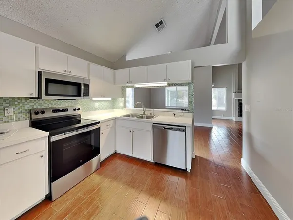 a kitchen with a stove a sink and a microwave