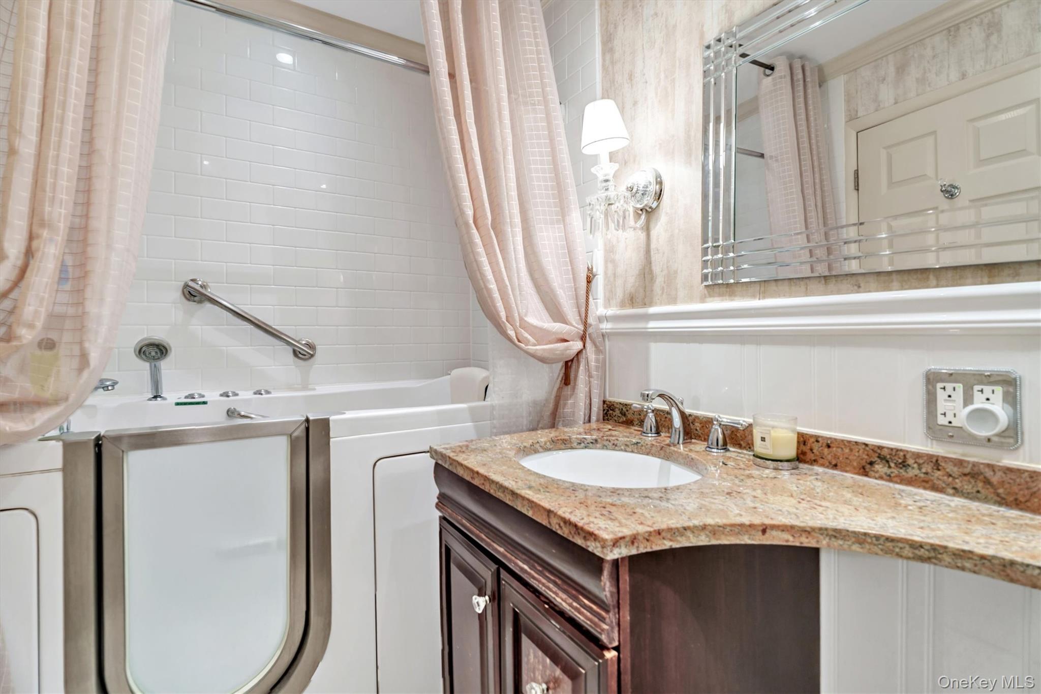 200 South Middle Neck Road, Unit J6 Great Neck, NY 11021 - Photo 16 of 22 a bathroom with a granite countertop sink and a mirror