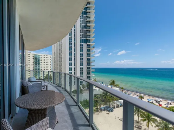 a balcony with chairs and table