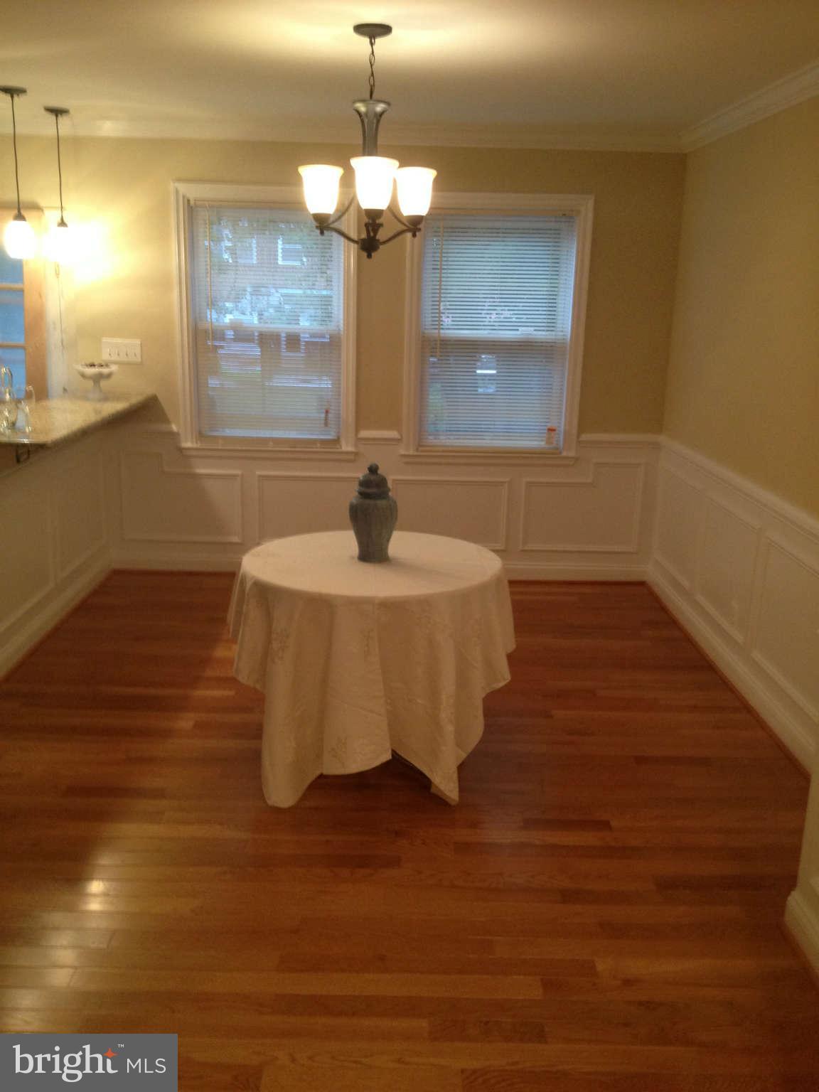4639 Marble Hall Road Baltimore, MD 21239 - Photo 22 of 30 a view of a room with wooden floor chandelier and windows