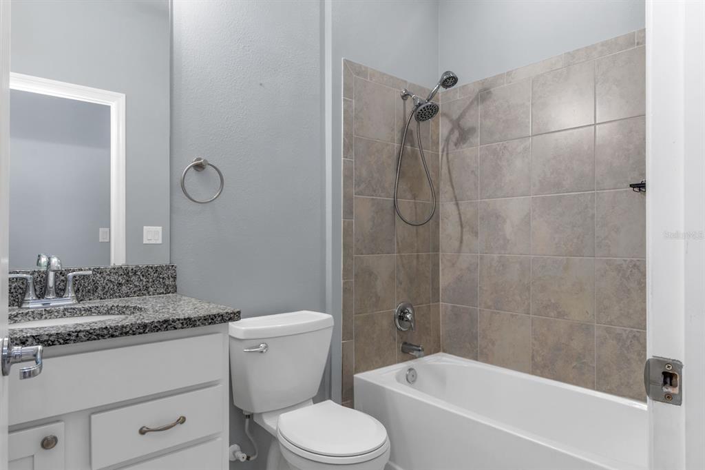 12653 Palapa Loop Spring Hill, FL 34610 - Photo 12 of 33 a bathroom with a sink toilet vanity and shower