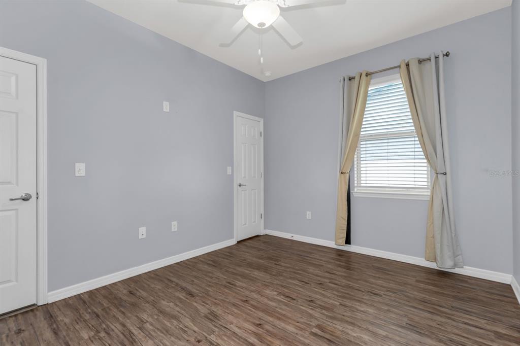 12653 Palapa Loop Spring Hill, FL 34610 - Photo 16 of 33 an empty room with wooden floor and windows