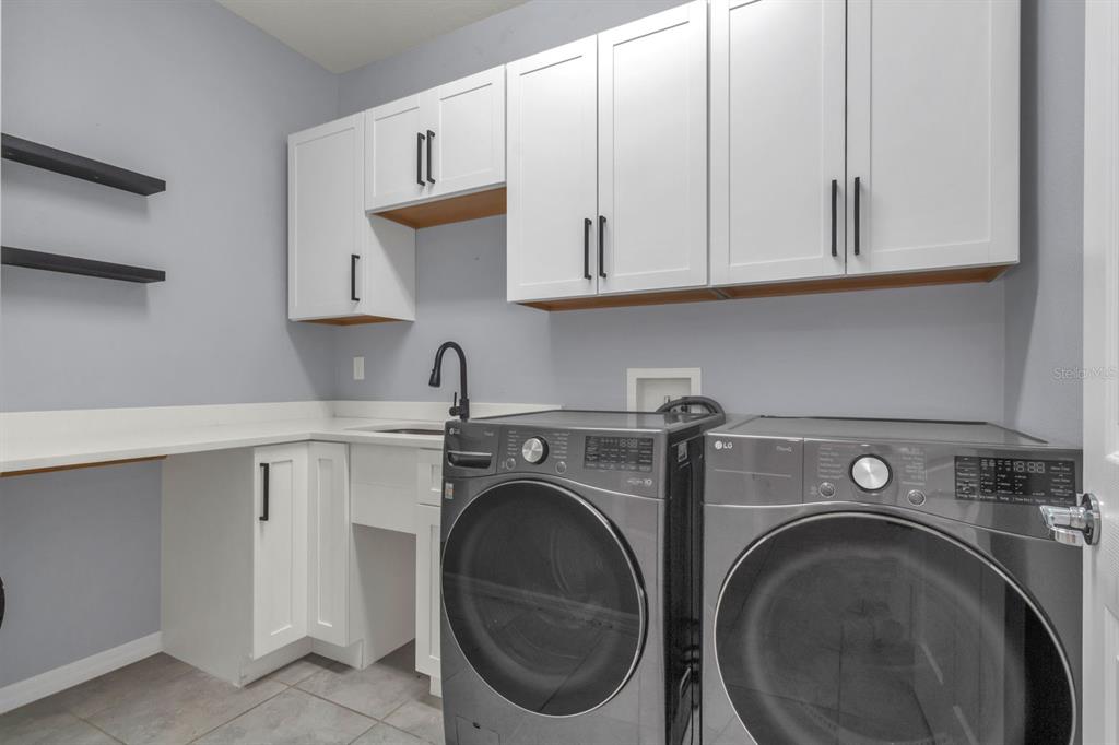 12653 Palapa Loop Spring Hill, FL 34610 - Photo 18 of 33 a utility room with sink dryer and washer