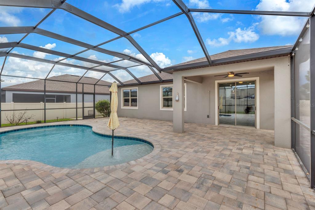 12653 Palapa Loop Spring Hill, FL 34610 - Photo 25 of 33 a view of a porch with a table and chairs