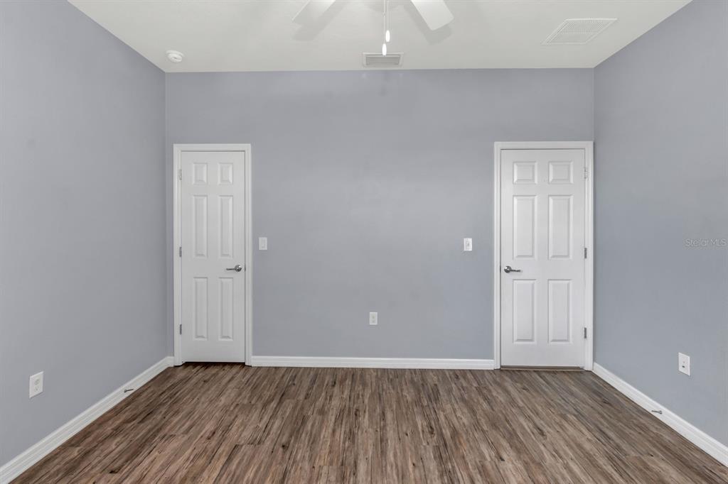 12653 Palapa Loop Spring Hill, FL 34610 - Photo 10 of 33 a view of an empty room with wooden floor and closet
