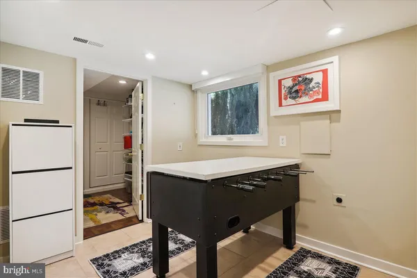 a backyard of a house with a bench and trees