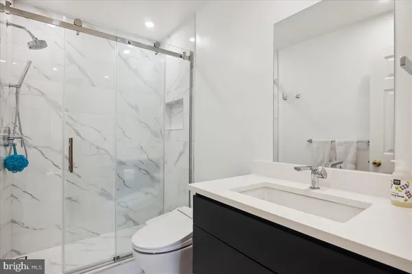 a living room with furniture and a night stand