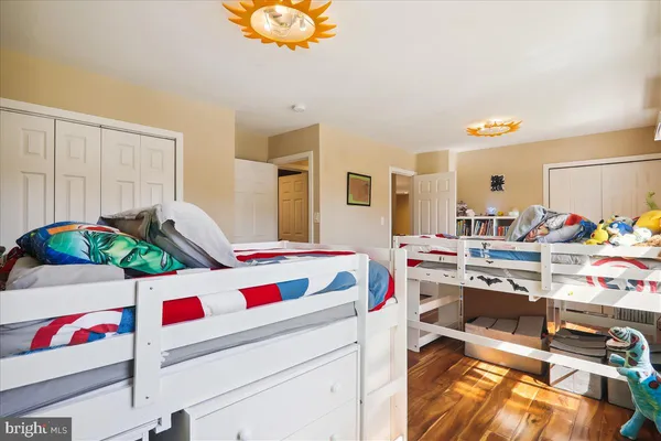 a view of entryway with furniture and wooden floor