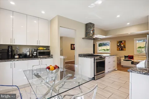 a kitchen with stainless steel appliances granite countertop a stove and a refrigerator