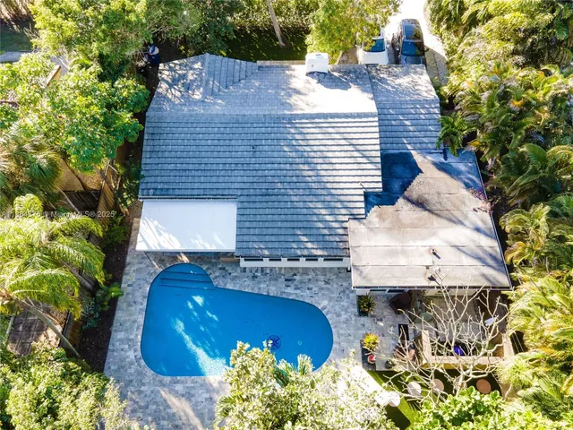 a aerial view of a house with a yard and garden