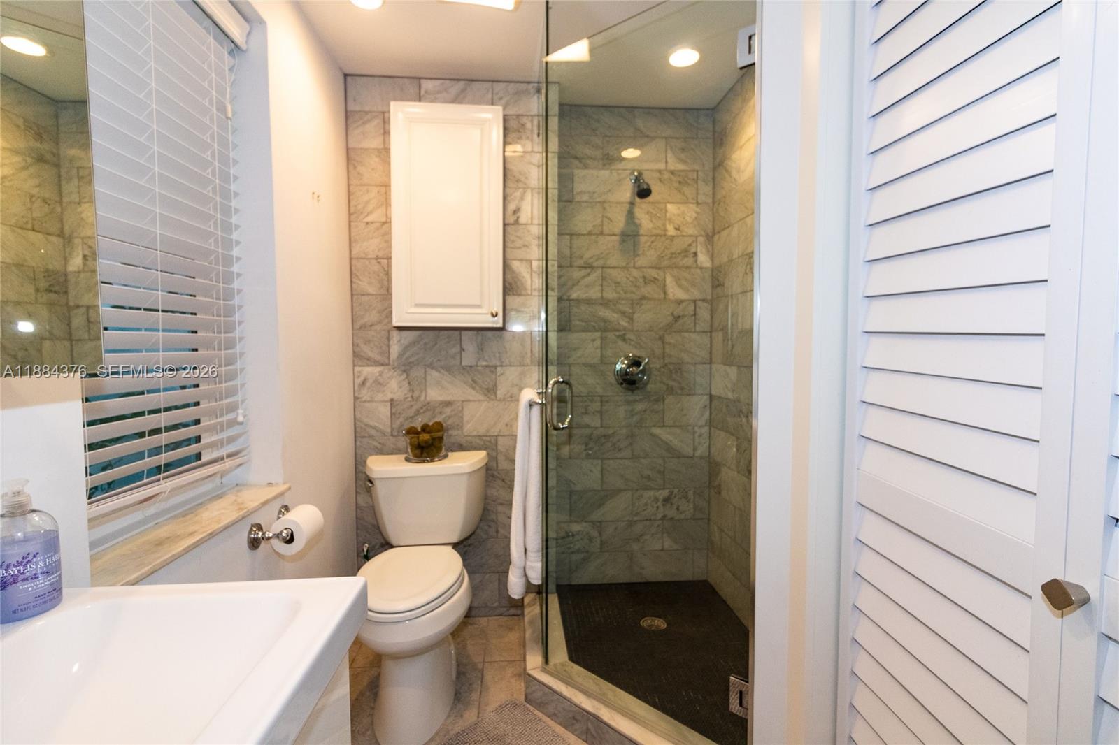 744 Northeast 16th Avenue Fort Lauderdale, FL 33304 - Photo 11 of 26 a bathroom with a toilet and a shower