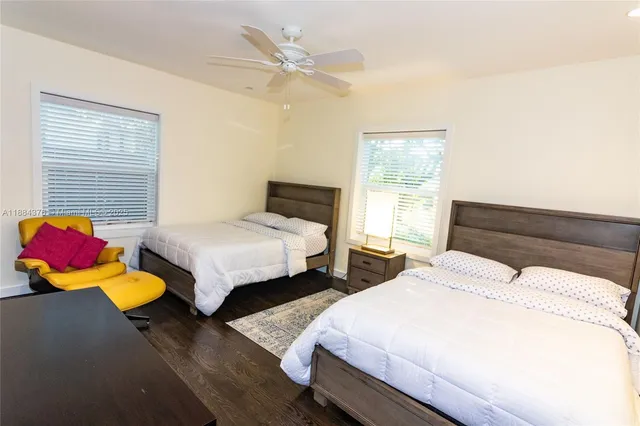 a bedroom with two beds and a window