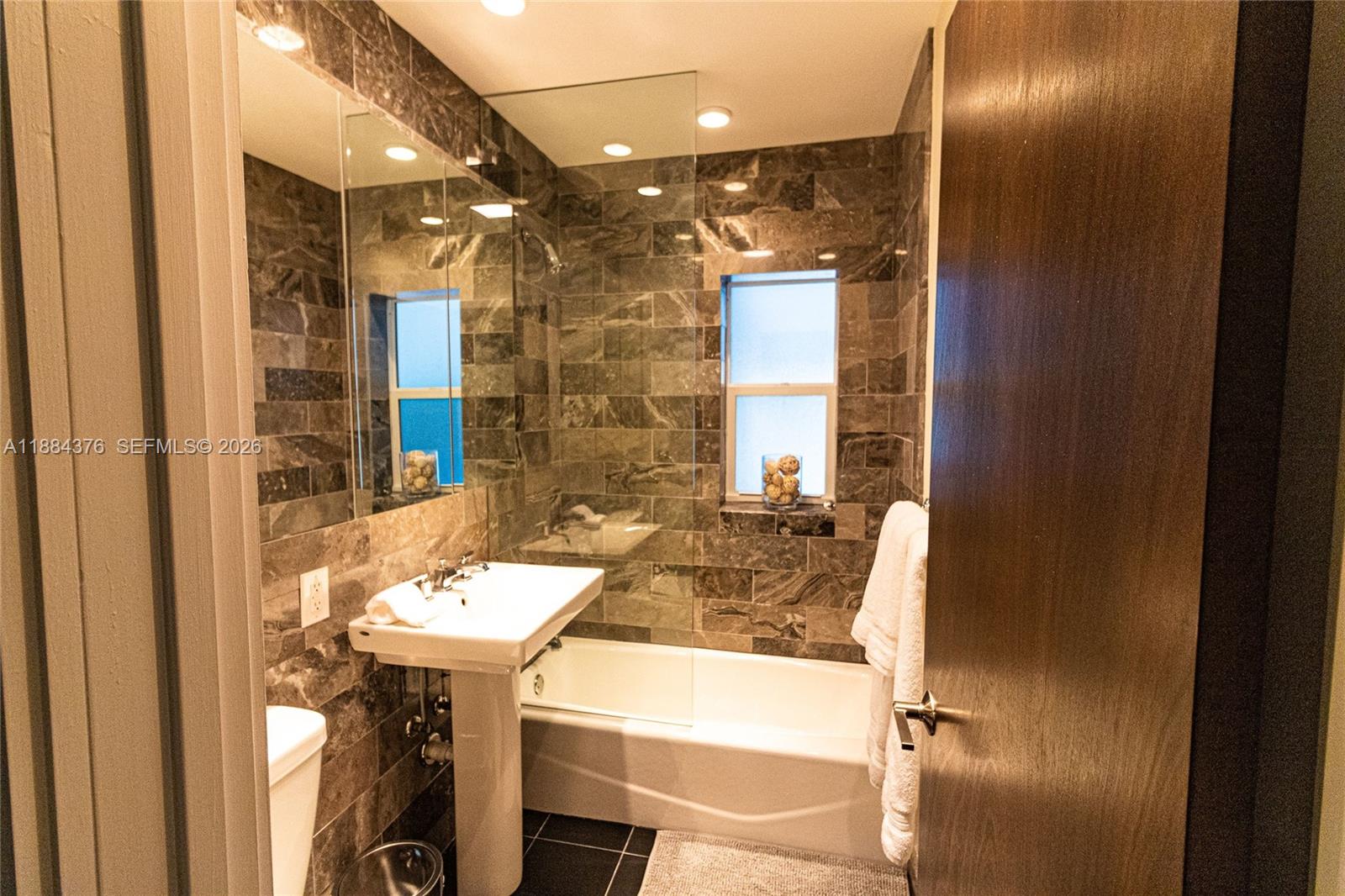 744 Northeast 16th Avenue Fort Lauderdale, FL 33304 - Photo 13 of 26 a bathroom with a sink and a mirror