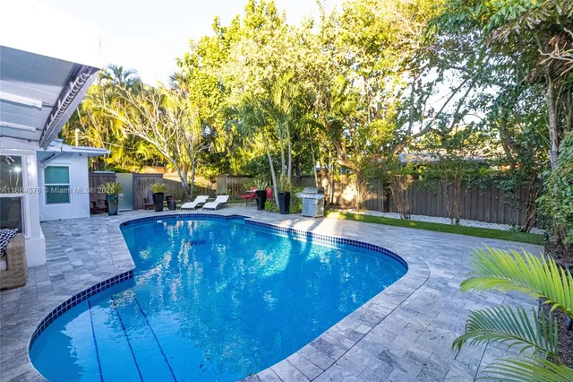 a view of a swimming pool with a patio