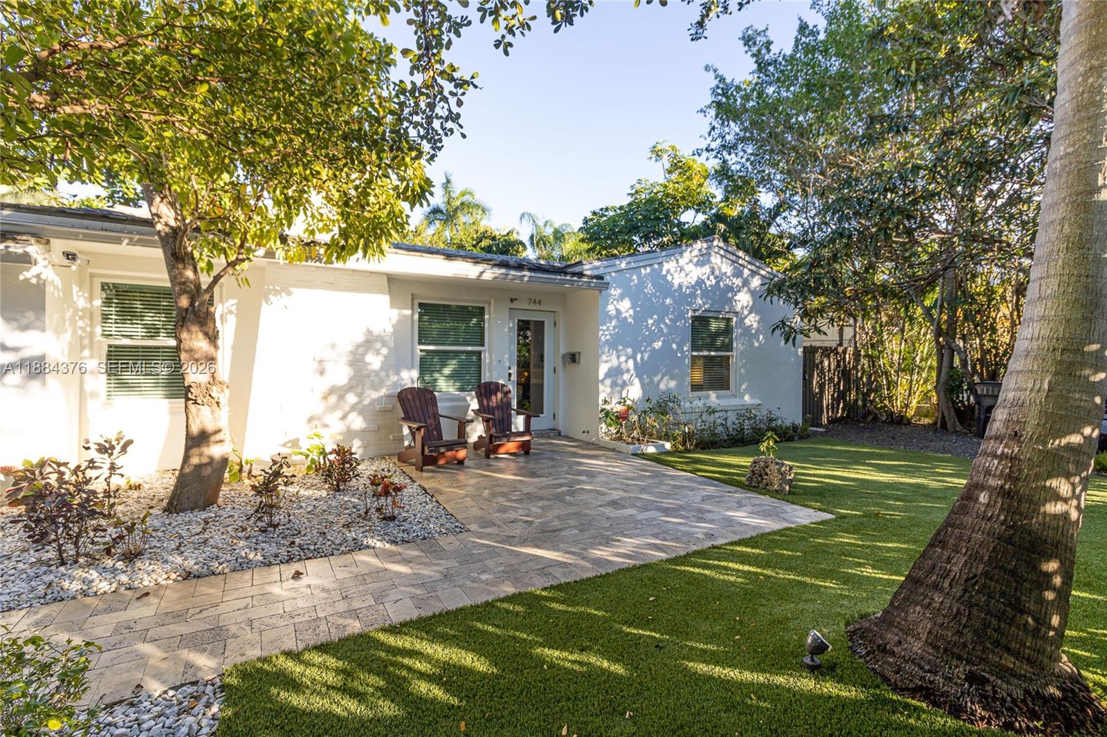 744 Northeast 16th Avenue Fort Lauderdale, FL 33304 - Photo 22 of 26 a view of a backyard with a sitting area and slide