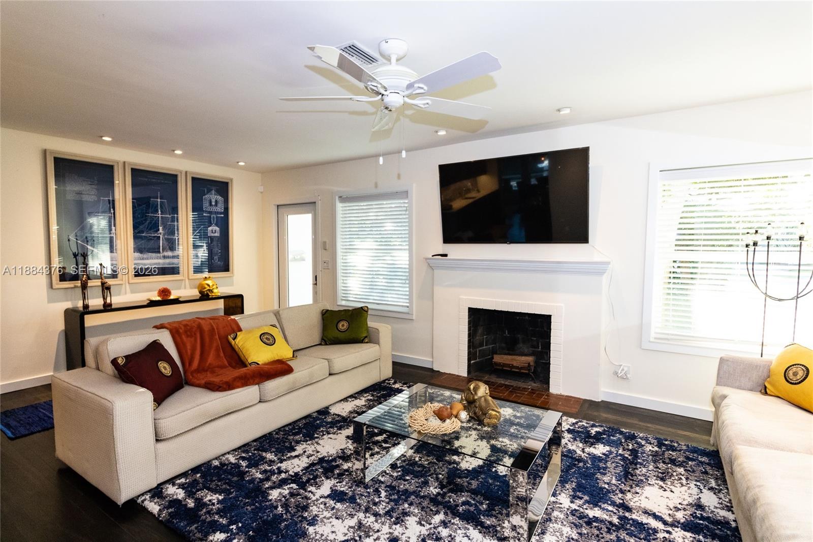 744 Northeast 16th Avenue Fort Lauderdale, FL 33304 - Photo 4 of 26 a living room with furniture fireplace and window