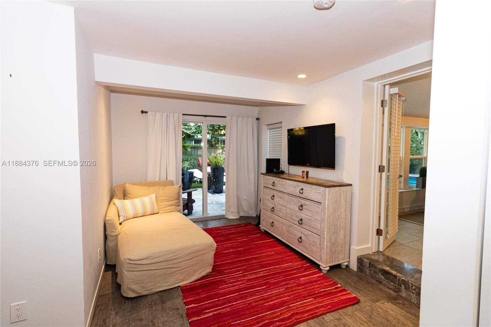 744 Northeast 16th Avenue Fort Lauderdale, FL 33304 - Photo 8 of 26 a room with a bed and a flat screen tv