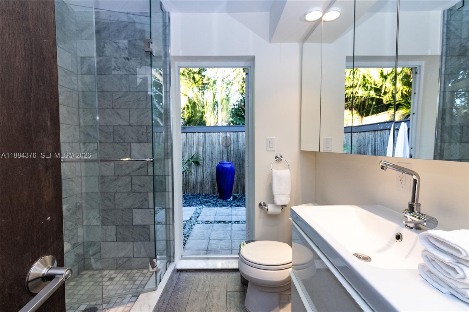744 Northeast 16th Avenue Fort Lauderdale, FL 33304 - Photo 9 of 26 a bathroom with a sink a toilet and shower