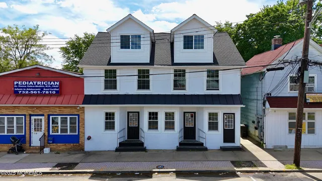 a front view of residential houses with yard