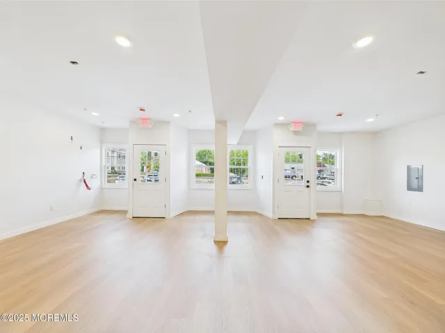 a view of a room with wooden floor and bathroom