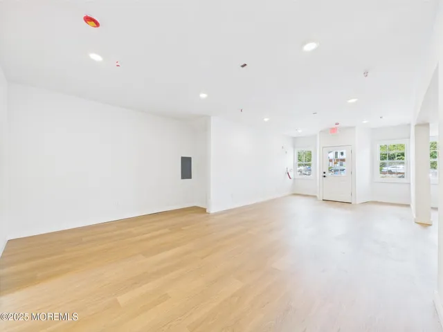 a large white kitchen with stainless steel appliances