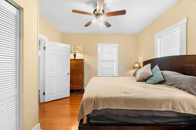 a large bed sitting in a bedroom next to a window