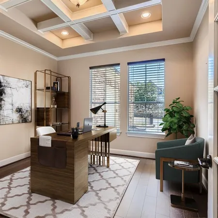a view of a workspace with furniture and a window