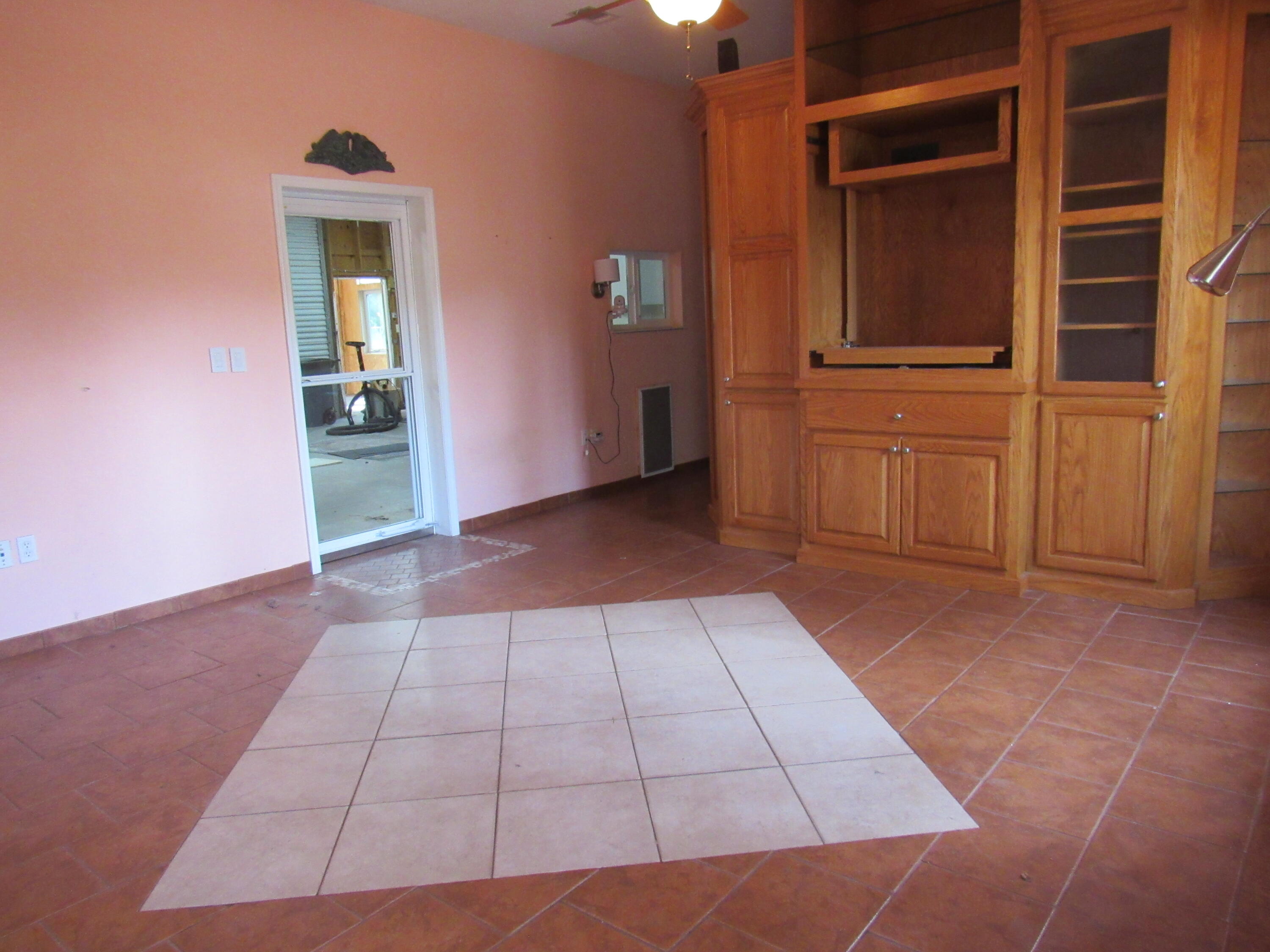 82 Palmetto Street Freeport, FL 32439 - Photo 15 of 55 a view of a hallway with wooden floor and a cabinet