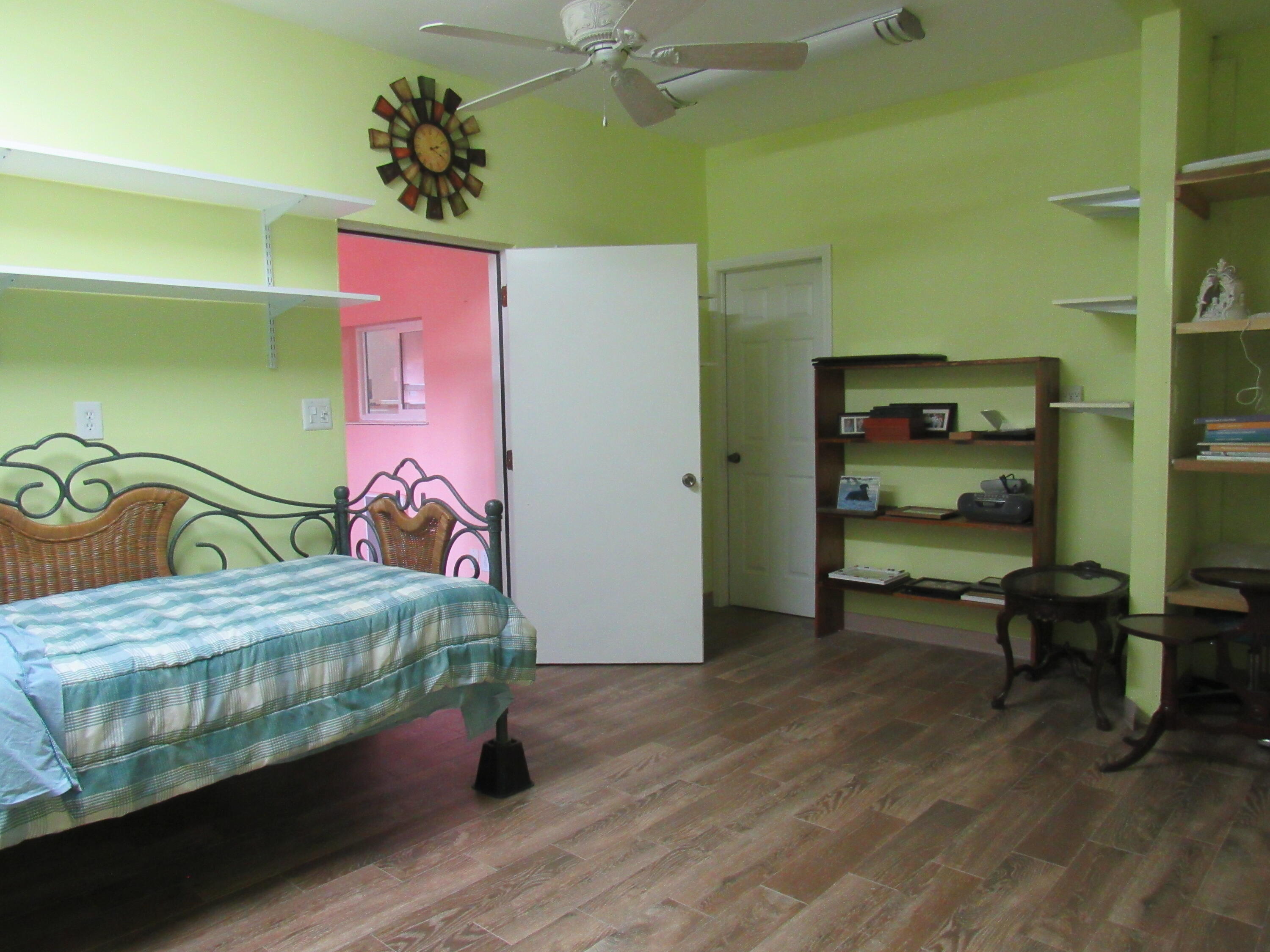 82 Palmetto Street Freeport, FL 32439 - Photo 19 of 55 a bedroom with a bed and a table in it