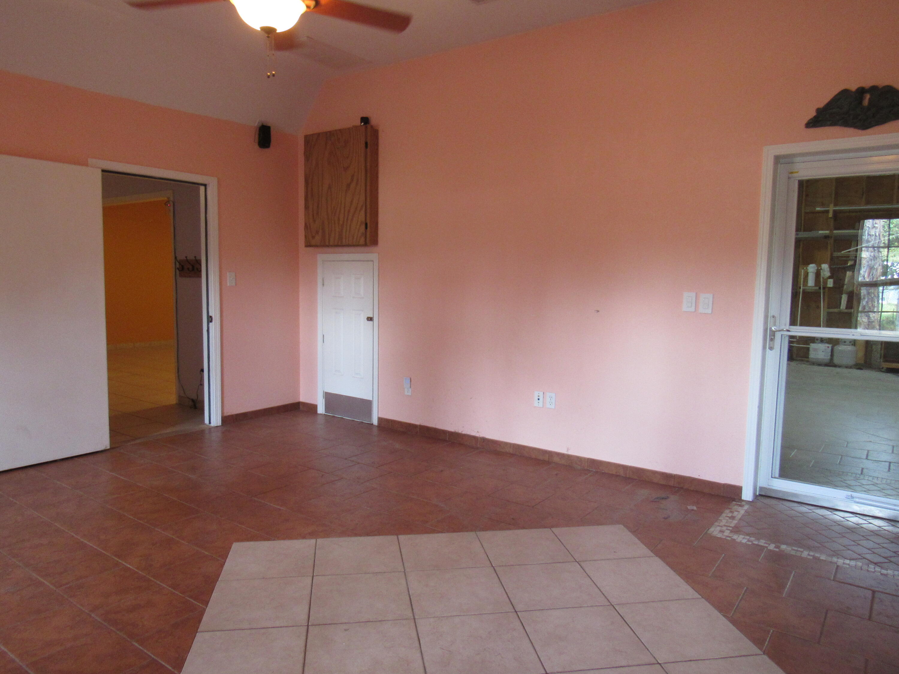 82 Palmetto Street Freeport, FL 32439 - Photo 22 of 55 a view of an empty room with window and cabinet