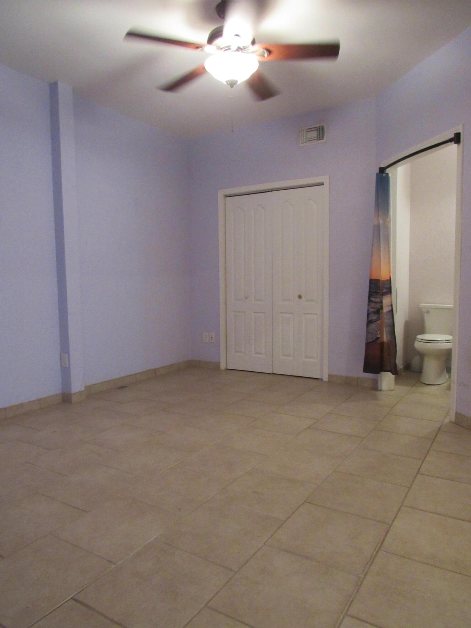 82 Palmetto Street Freeport, FL 32439 - Photo 26 of 55 a view of an empty room with a chandelier fan