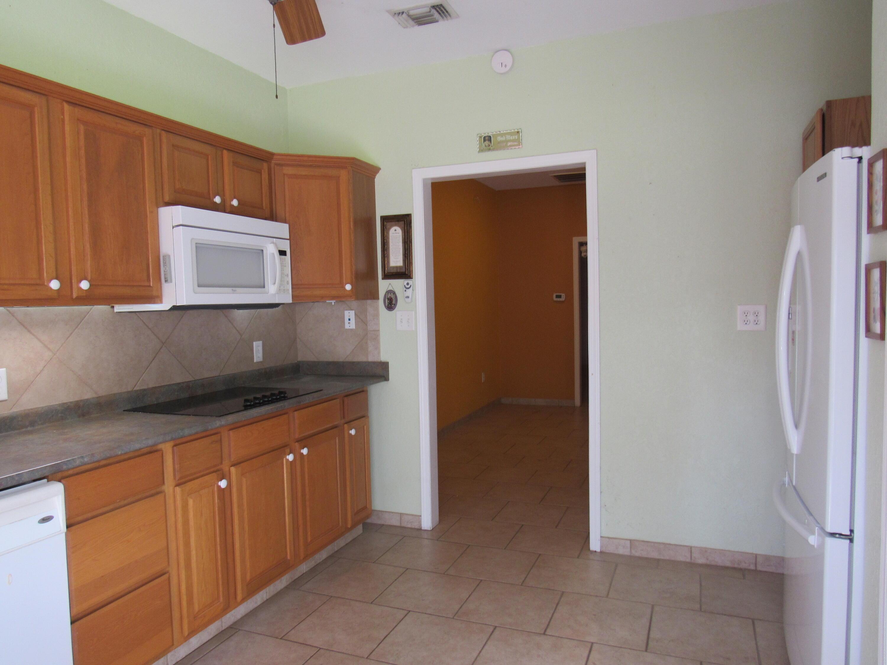 82 Palmetto Street Freeport, FL 32439 - Photo 34 of 55 a kitchen with stainless steel appliances granite countertop a refrigerator and a sink
