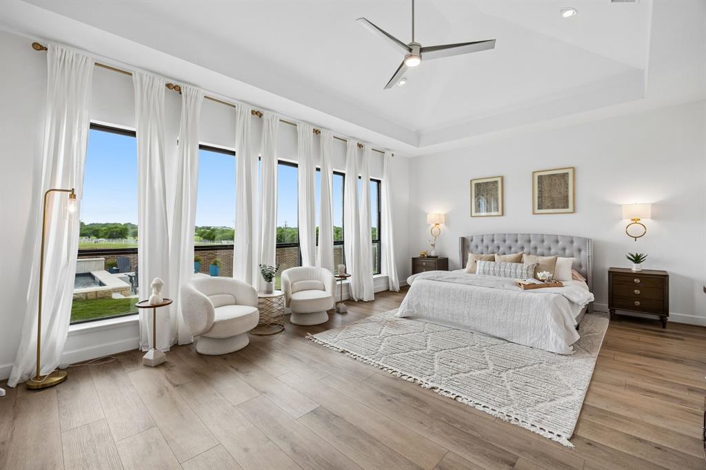 1908 Lotus Court Haslet, TX 76052 - Photo 17 of 40 Primary Retreat With Wall Of Windows, Soaring Ceilings, And Sconce Lighting