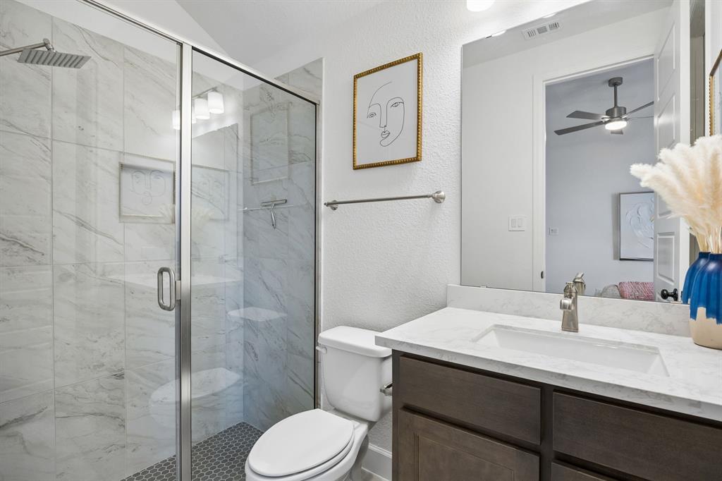 1908 Lotus Court Haslet, TX 76052 - Photo 31 of 40 Private Bath Featuring Glass-Enclosed Tile Shower and Rich Cabinets