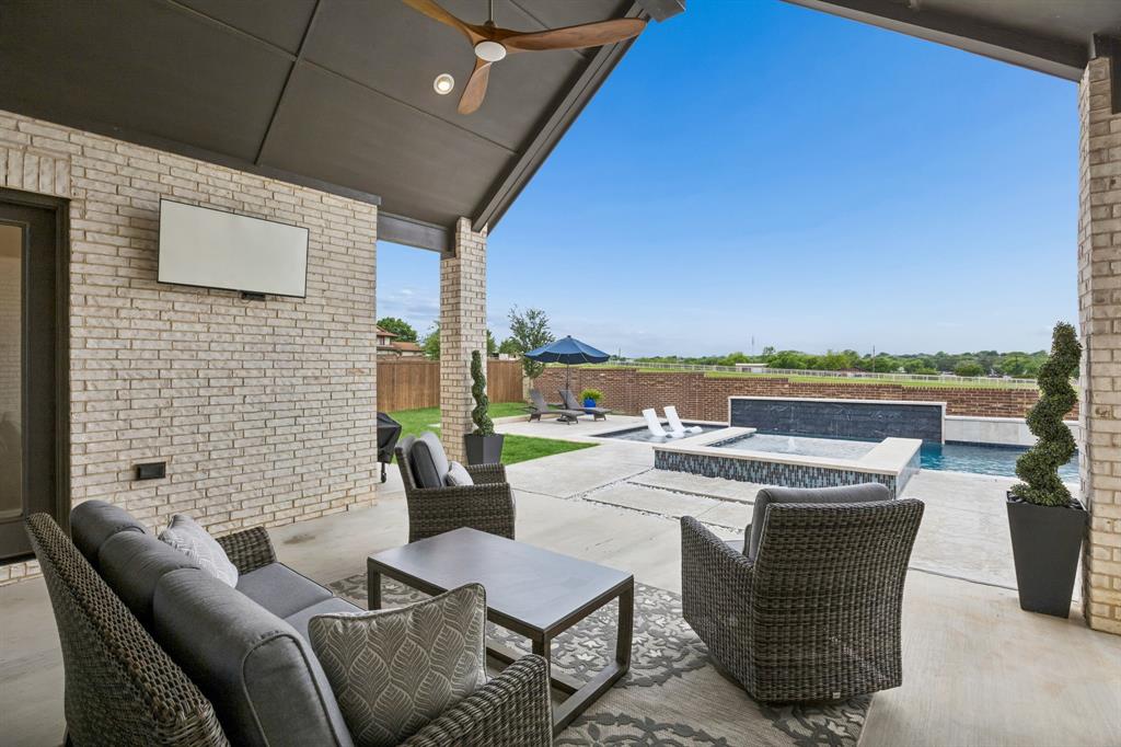 1908 Lotus Court Haslet, TX 76052 - Photo 35 of 40 Expansive Covered Patio Featuring Ceiling Fan And Entertainment Wiring