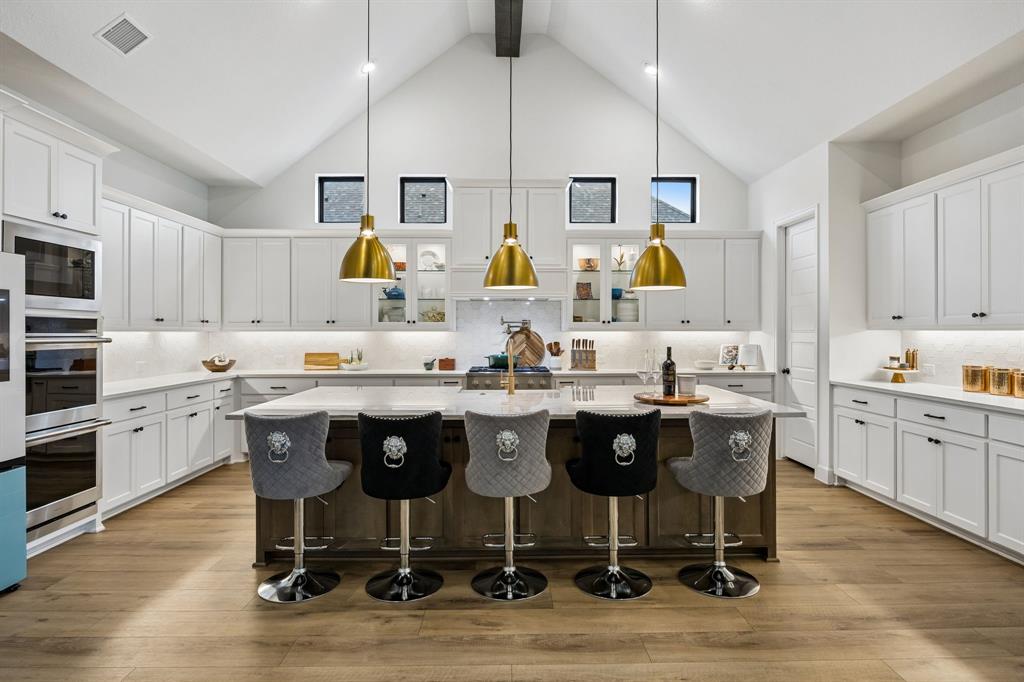 1908 Lotus Court Haslet, TX 76052 - Photo 6 of 40 Stunning Statement Kitchen Featuring Quartzite Island, Pendant Lighting, And Custom Cabinetry